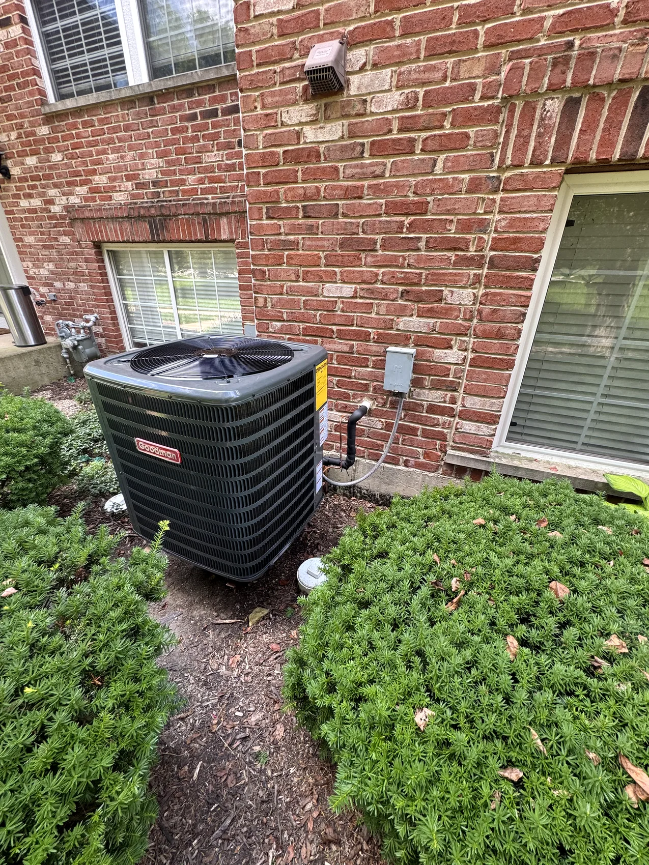Outdoor AC condenser serviced by Premier Air