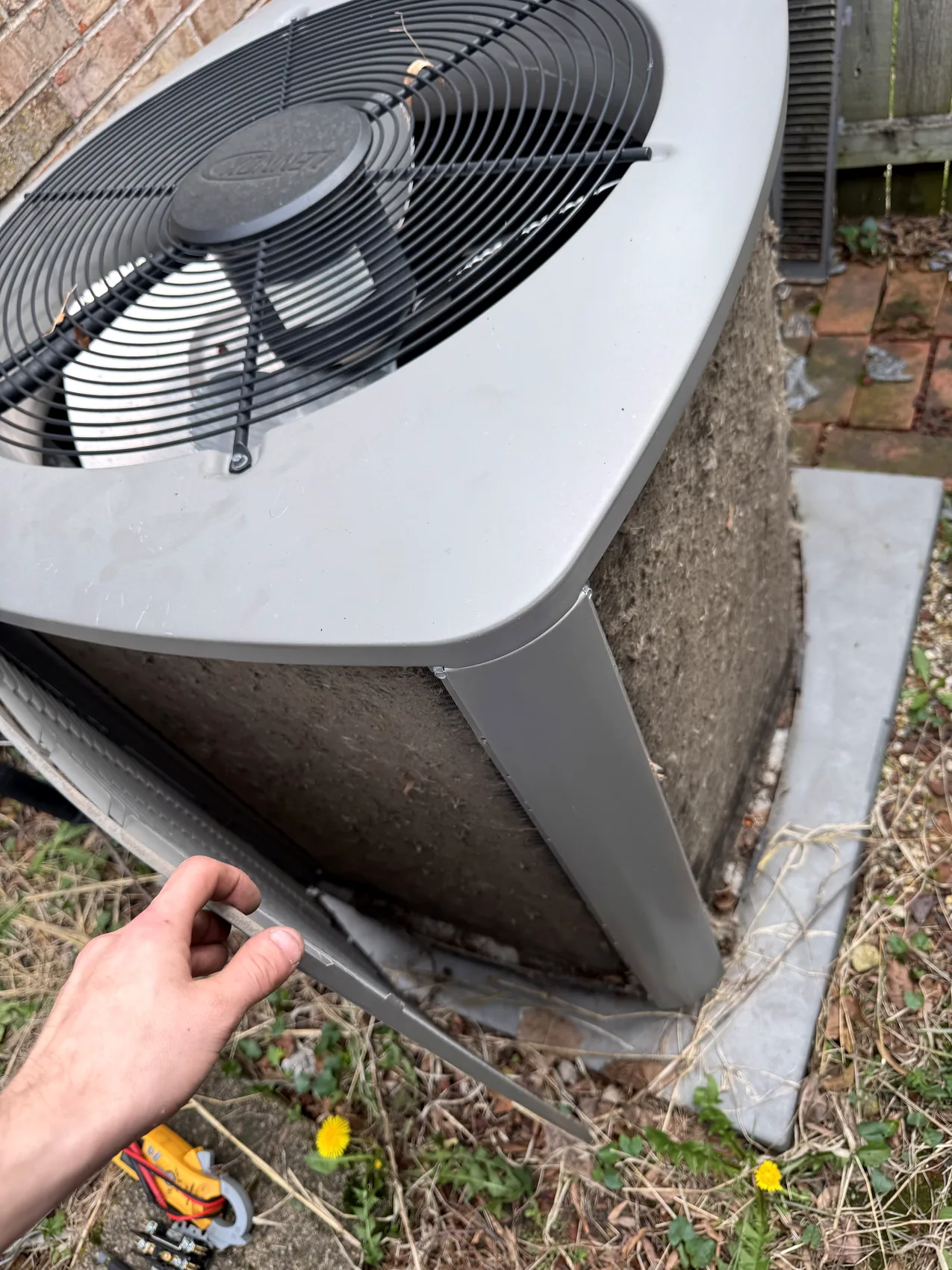 Technician gauges connected during residential AC service